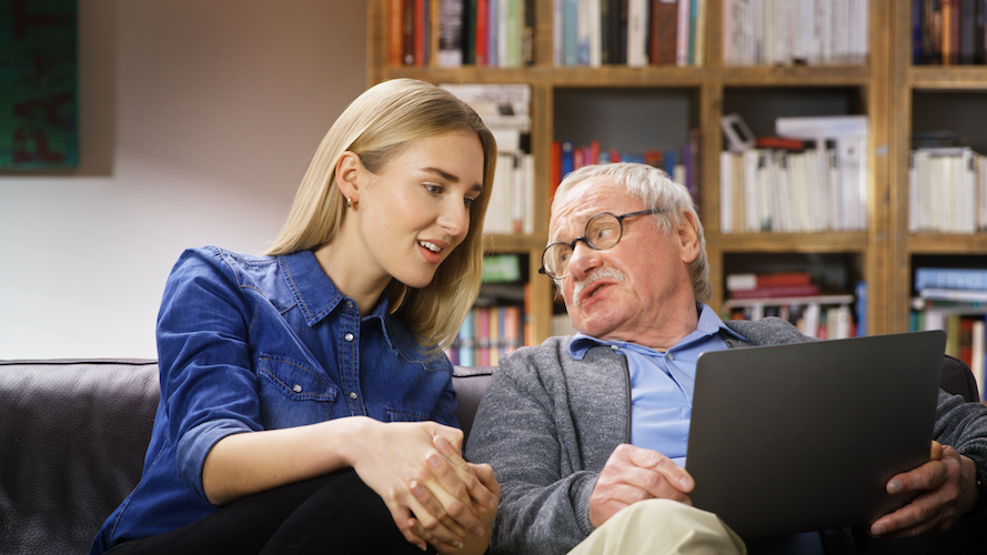 Grandpa explains the Allianz insurance to grandchild on the couch